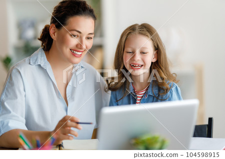 Girl doing homework or online education. Girl doing homework or online education. 104598915