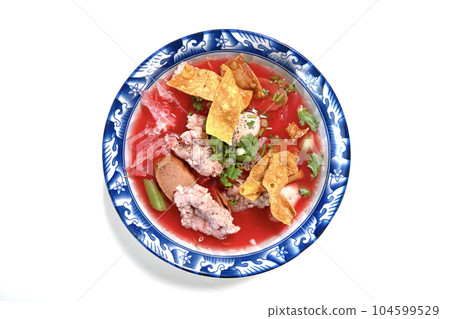 Yen Ta Fo in pink soup with fish balls, crispy wontons, and jellyfish In an ancient patterned bowl on a white background Yen Ta Fo in pink soup with fish balls, crispy wontons, and jellyfish In an ancient patterned bowl on a white background 104599529