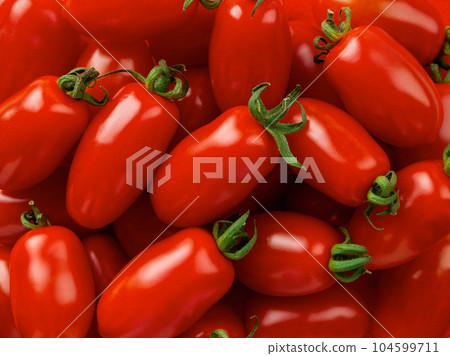 Raw Ornela cherry tomatoes macro background. Raw Ornela cherry tomatoes macro background. 104599711