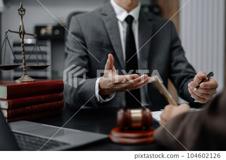 Business people and lawyers discussing contract papers sitting in the table at office in the morning. concepts of law, advice, legal services. 104602126