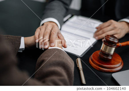 Legal advisers encourage clients. Justice and lawyer concept in the office. 104602140