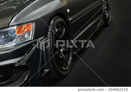 Front headlights of black modify car on black background Front headlights of black modify car on black background 104602250