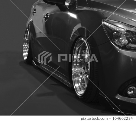 Front headlights of black modify car on black background 104602254