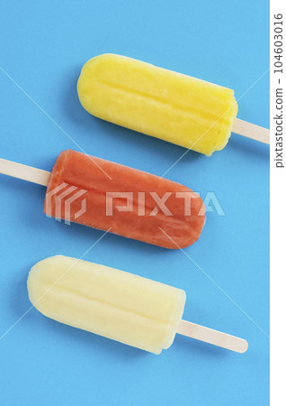 Close-up of popsicles on a blue background Close-up of popsicles on a blue background 104603016