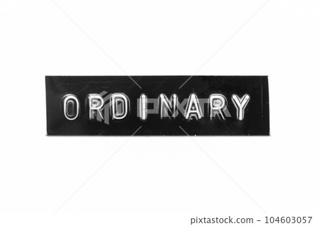 Black color banner that have embossed letter with word ordinary on white paper background 104603057