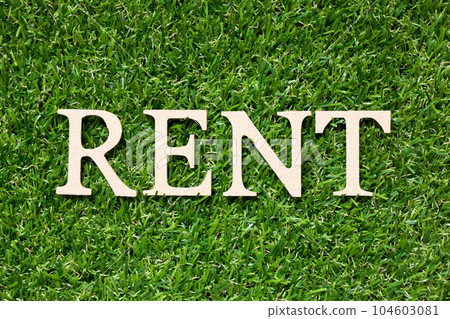 Wood alphabet letter in word rent on artificial green grass background Wood alphabet letter in word rent on artificial green grass background 104603081