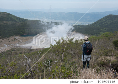Mt. Shiratori and the steam and climbers of an active volcano seen from the mountain trail of Mt. Karakuni on Mt. Mt. Shiratori and the steam and climbers of an active volcano seen from the mountain trail of Mt. Karakuni on Mt. 104605346