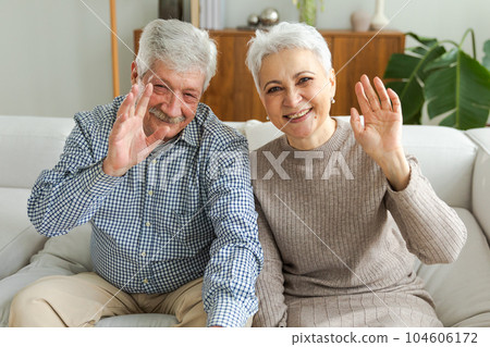 Happy senior woman man talk on video call with friends family. Mature old grandmother grandfather talking speaking with grown up children online. Older generation modern tech usage. Webcamera view Happy senior woman man talk on video call with friends family. Mature old grandmother grandfather talking speaking with grown up children online. Older generation modern tech usage. Webcamera view 104606172