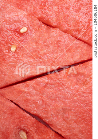 Fresh watermelon triangular slices as background or texture for summer fruits, vertical image. 104606184