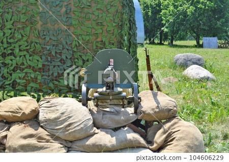 Maxim machine gun from the First World War with a machine gunner. Maxim machine gun from the First World War with a machine gunner. 104606229
