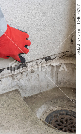 Workers inspecting deterioration of outer wall joints Workers inspecting deterioration of outer wall joints 104606297