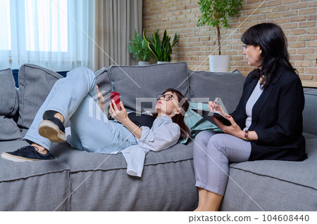 Middle aged frustrated sad woman in psychological therapy session 104608440