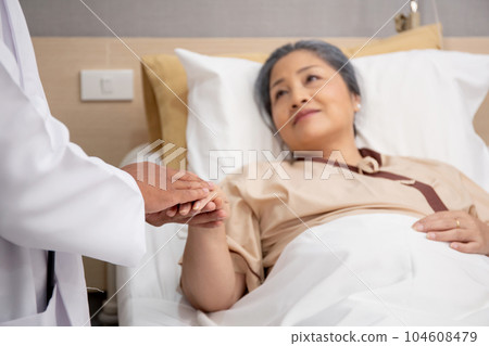 Closeup hands of doctor man encourage with elderly patient at the hospital. Closeup hands of doctor man encourage with elderly patient at the hospital. 104608479