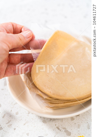 Filling empanada dough with cherry pie filling to make sweet cherry empanadas in the air fryer. Filling empanada dough with cherry pie filling to make sweet cherry empanadas in the air fryer. 104611727