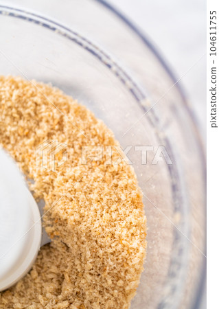 Crumbling stale bread in a food processor to make bread crumbs. Crumbling stale bread in a food processor to make bread crumbs. 104611755