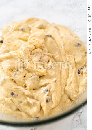 Rising dough in a glass mixing bowl to bake mini Easter bread kulich. Rising dough in a glass mixing bowl to bake mini Easter bread kulich. 104611774