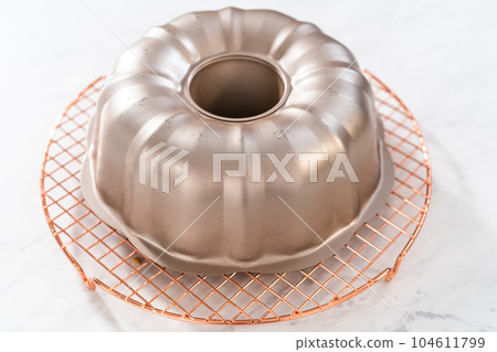 Cooling freshly baked lemon blueberry bundt cake on the kitchen counter. 104611799