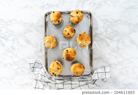 Cooling freshly baked mini Easter bread kulich on a kitchen counter. 104611883