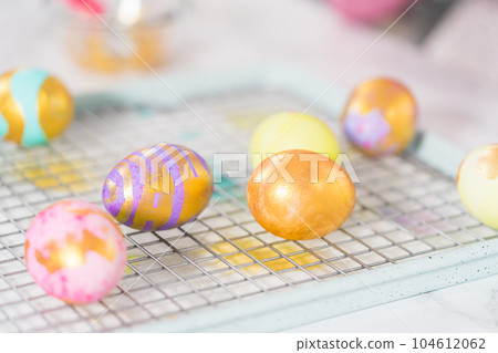 Easter egg coloring. Painting Easter eggs with gold luster. Easter egg coloring. Painting Easter eggs with gold luster. 104612062