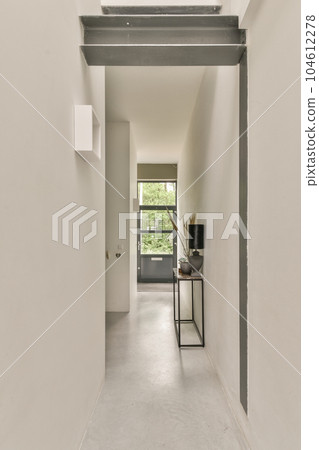 an empty room with white walls and grey trim on the wall, there is a small desk in the corner an empty room with white walls and grey trim on the wall, there is a small desk in the corner 104612278