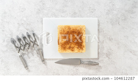 Flat lay. Scoring eggnog fudge with a wheel dough cutter for cutting into small pieces. Flat lay. Scoring eggnog fudge with a wheel dough cutter for cutting into small pieces. 104612287