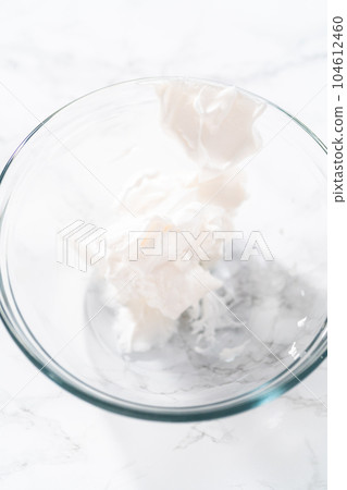 Mixing food coloring into the meringue to bake meringue cookies. Mixing food coloring into the meringue to bake meringue cookies. 104612460