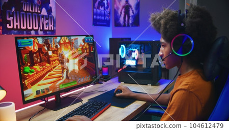 African American gamer plays on PC at home 104612479