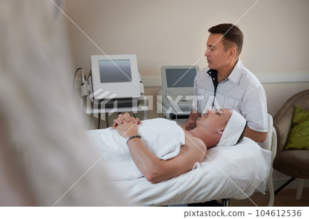 handsome man on RF lifting procedure in medicine clinic handsome man on RF lifting procedure in medicine clinic 104612536