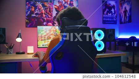 African American gamer plays on PC at home African American gamer plays on PC at home 104612548
