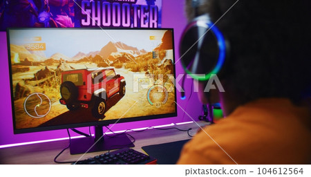 Teenager plays in online 3D racing game on powerful computer Teenager plays in online 3D racing game on powerful computer 104612564