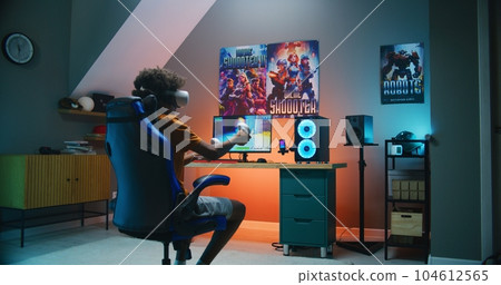 African American teenager in VR headset plays virtual third-person 3D shooter African American teenager in VR headset plays virtual third-person 3D shooter 104612565