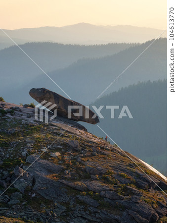 Falling large boulder on the edge of the abyss. Vertical view, Western Sayan. Natural Park Ergaki. Krasnoyarsk region. Russia. Falling large boulder on the edge of the abyss. Vertical view, Western Sayan. Natural Park Ergaki. Krasnoyarsk region. Russia. 104613770