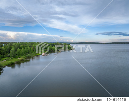Big lake with green shores in bright sun light, aerial landscape. Recreation concept. Aerial view 104614656