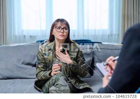 Middle-aged woman in military uniform at psychological therapy session 104615728