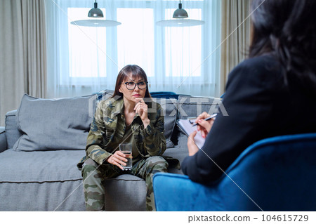 Middle-aged woman in military uniform at psychological therapy session Middle-aged woman in military uniform at psychological therapy session 104615729