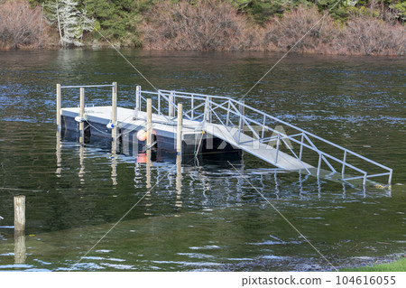 Photograph of boat moorings in flood waters at the Manapouri Boat Club in New Zealand 104616055