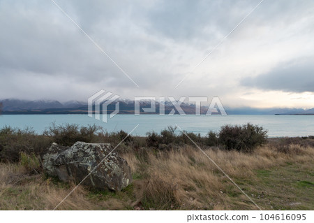 Photograph of Lake Pukaki on a cloudy day on the South Island of New Zealand Photograph of Lake Pukaki on a cloudy day on the South Island of New Zealand 104616095