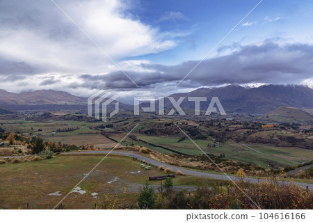 Photograph of a mountain range and large valley in Queenstown on the South Island of New Zealand Photograph of a mountain range and large valley in Queenstown on the South Island of New Zealand 104616166