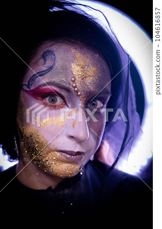 Witch girl with fancy makeup a Halloween holiday Witch girl with fancy makeup a Halloween holiday 104616857