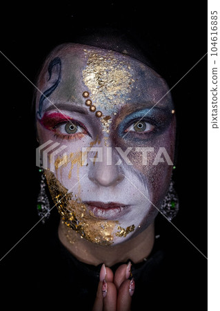 Witch girl with fancy makeup a Halloween holiday 104616885