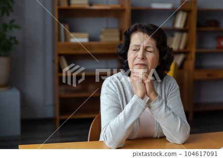Sad tired ill sick lonely disappointed older senior woman sitting at home alone. Unhappy mature grandmother experiencing grief relative death bad news. Stressed elder lady suffering from loneliness Sad tired ill sick lonely disappointed older senior woman sitting at home alone. Unhappy mature grandmother experiencing grief relative death bad news. Stressed elder lady suffering from loneliness 104617091