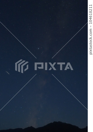 Milky Way galaxy rising from the Southern Alps in Hakushu Town, Hokuto City 104618211