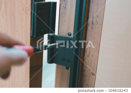 front door hinges and screwdrivers 104618243