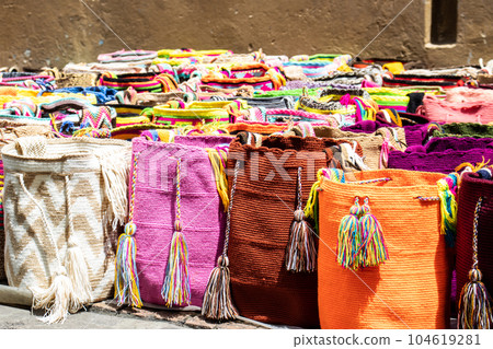 Street selling in Bogota of traditional bags hand knitted by women of the Wayuu community in Colombia called mochilas Street selling in Bogota of traditional bags hand knitted by women of the Wayuu community in Colombia called mochilas 104619281