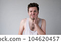 Poor caucasian man has a toothache. Studio shot 104620457