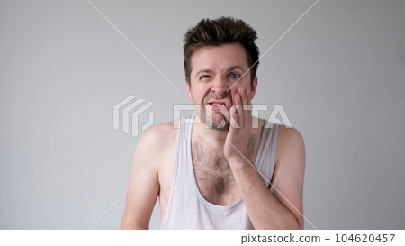 Poor caucasian man has a toothache. Studio shot 104620457