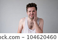 Poor caucasian man has a toothache. Studio shot 104620460