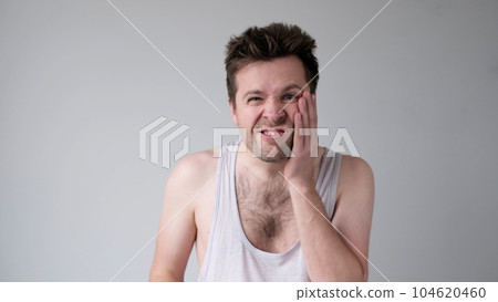 Poor caucasian man has a toothache. Studio shot 104620460