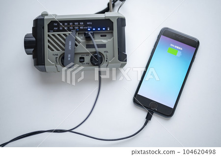 Charging smartphone from disaster prevention radio Charging smartphone from disaster prevention radio 104620498