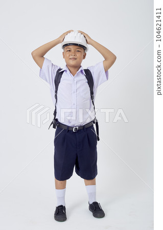 A young Asian cute boy standing in a Thai school uniform with a backpack bag and safety helmet  on a white background banner A young Asian cute boy standing in a Thai school uniform with a backpack bag and safety helmet  on a white background banner 104621411